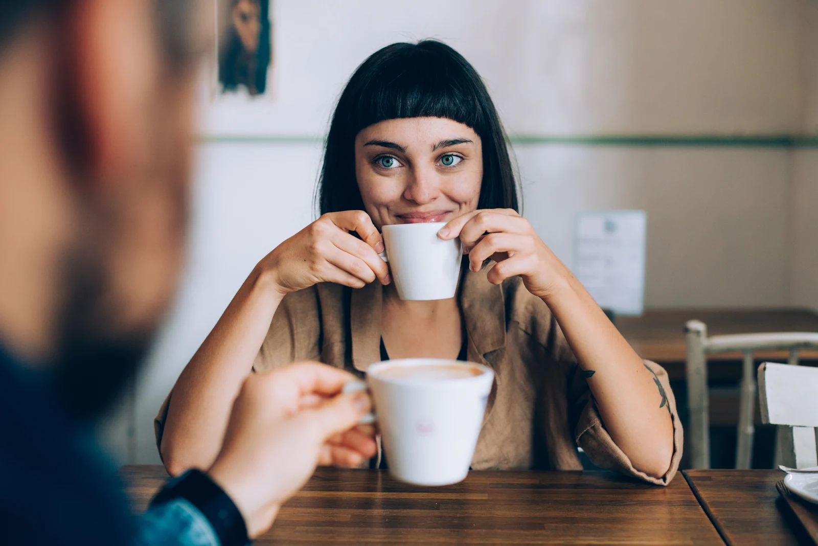 Foto einer Frau, die mit einem Mann Kaffee trinkt